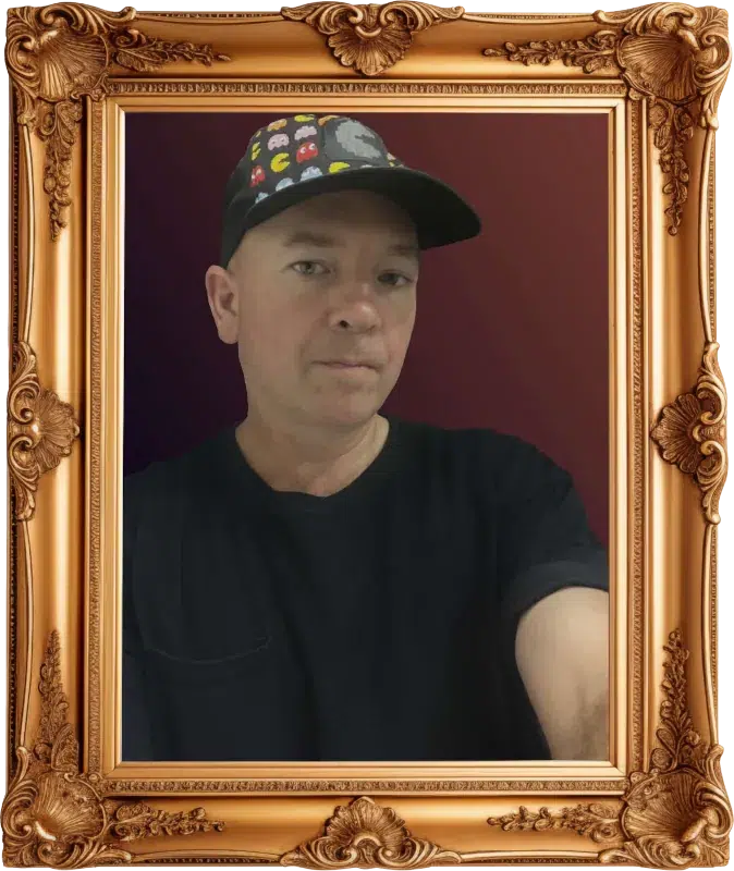 David Noll Self Portrait Photo An image of David Noll wearing a Pacman hat inside a golden picture frame.