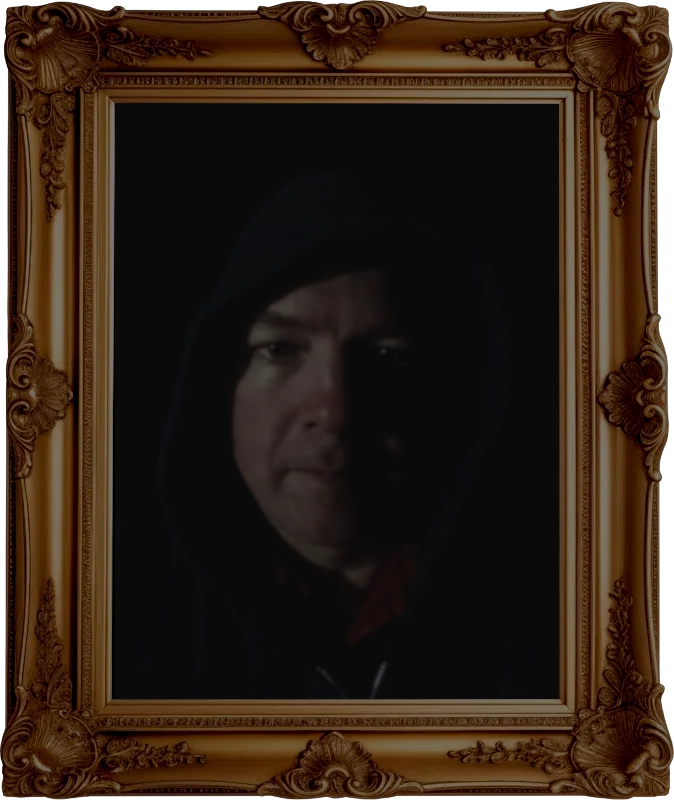 An image of David Noll wearing a Pacman hat inside a golden picture frame.